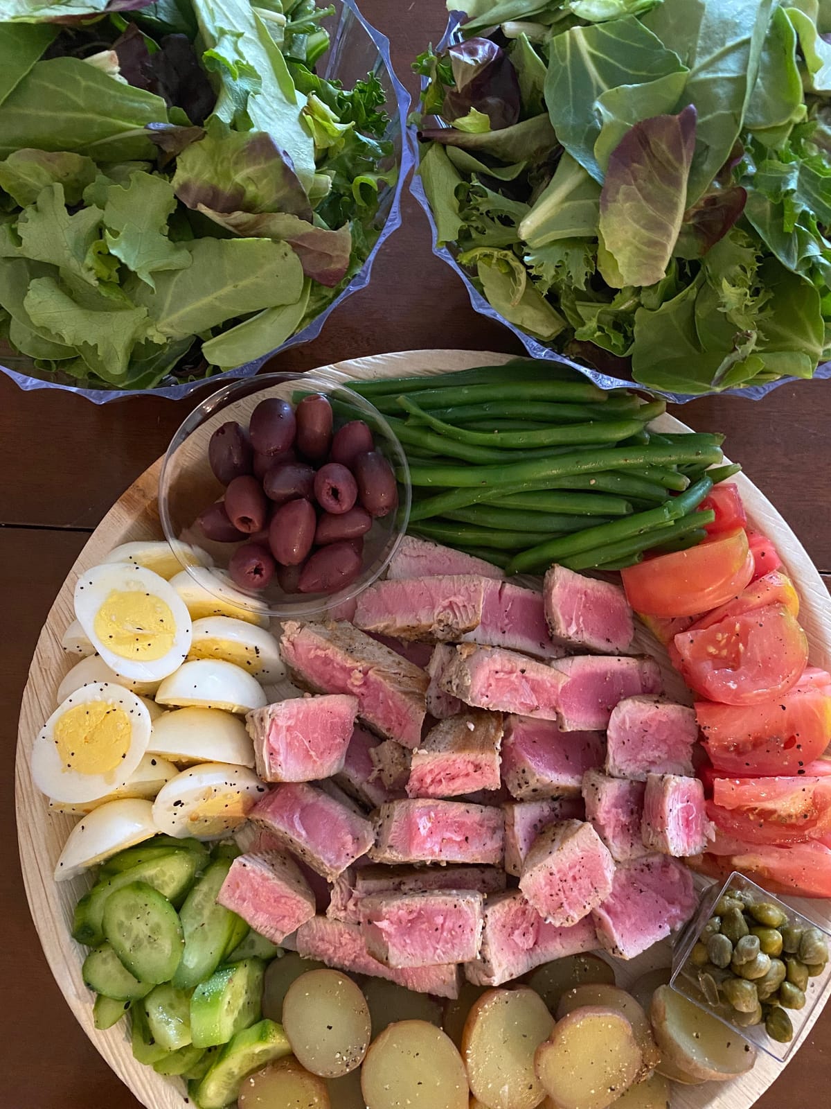 Salad Niçoise board with seared tuna, eggs, olives and green beans