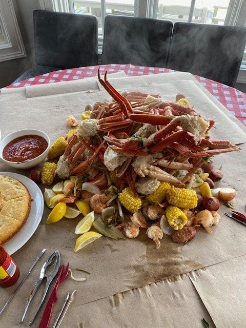 Lowcountry seafood boil piled with crab legs, shrimp and corn